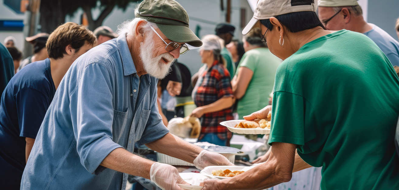 Volunteers providing plates of food at food drive.