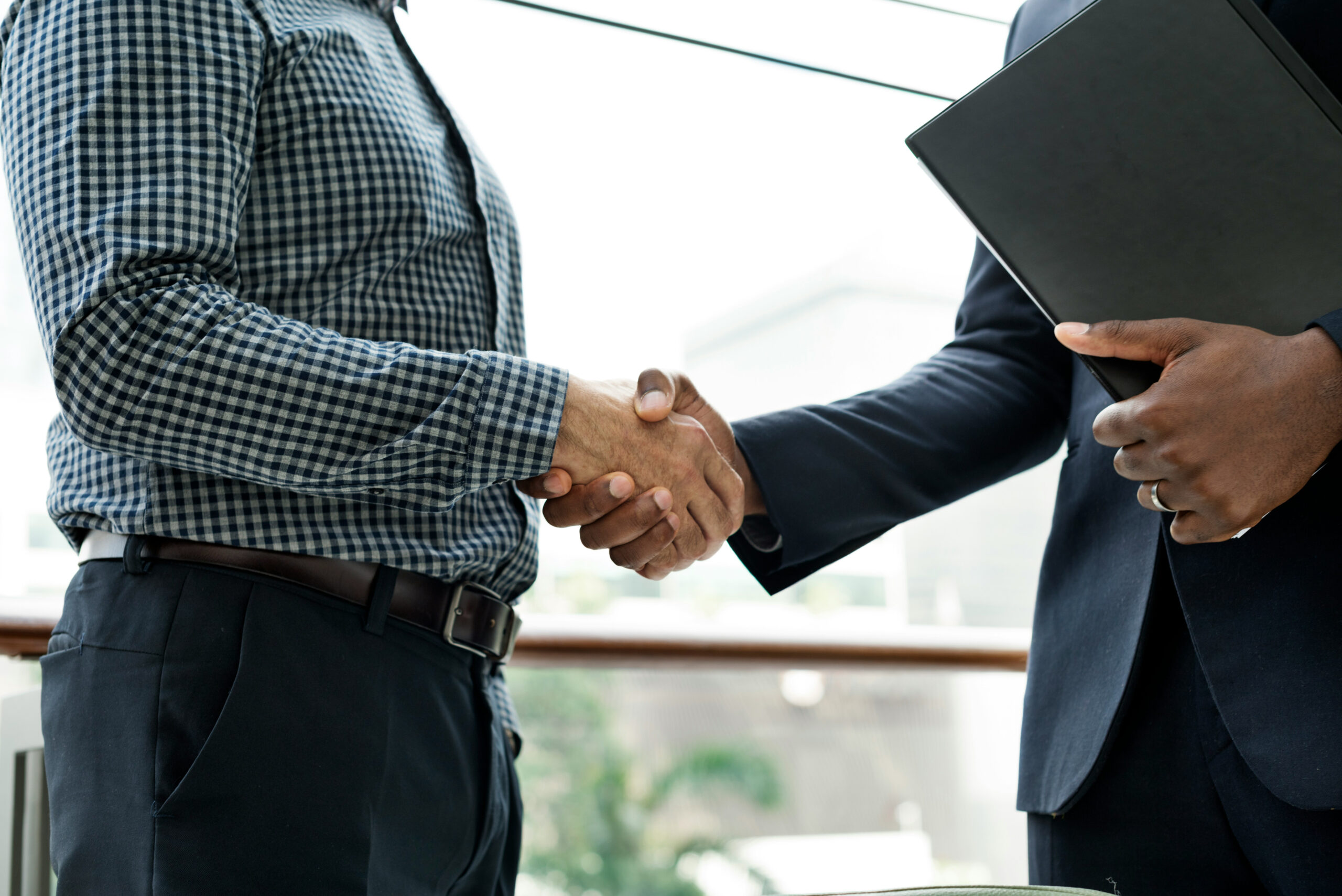 People shaking hands over a business deal.